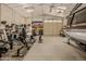 Large garage space with weight training equipment, tools, and boat storage at 5511 N 128Th Dr, Litchfield Park, AZ 85340