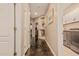 Hallway with dark floors featuring a nook with decor and white doors leading to other rooms at 5511 N 128Th Dr, Litchfield Park, AZ 85340