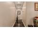 Neutral hallway with a sleek black concrete floor and multiple doorways at 5511 N 128Th Dr, Litchfield Park, AZ 85340