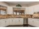 Bright kitchen with white cabinets, stainless steel appliances, and granite countertops at 5511 N 128Th Dr, Litchfield Park, AZ 85340