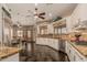 Spacious kitchen with breakfast bar, granite countertops, and stainless appliances open to living area at 5511 N 128Th Dr, Litchfield Park, AZ 85340