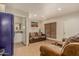 Inviting living room with comfortable seating and adjacent bathroom at 5511 N 128Th Dr, Litchfield Park, AZ 85340