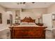 Spacious main bedroom suite with a luxurious bed, decorative lamps, and a cozy ambiance at 5511 N 128Th Dr, Litchfield Park, AZ 85340