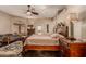 A primary bedroom features a decorative ceiling fan, decorative furniture and outside access at 5511 N 128Th Dr, Litchfield Park, AZ 85340