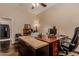Office featuring a large desk, a ceiling fan, dark floors, and decor items on display at 5511 N 128Th Dr, Litchfield Park, AZ 85340
