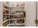 Walk-in pantry with ample shelving for organized food storage at 5511 N 128Th Dr, Litchfield Park, AZ 85340