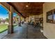 Spacious covered patio with wood ceilings and access to an outdoor kitchen and dining area at 5511 N 128Th Dr, Litchfield Park, AZ 85340