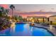 Backyard oasis with a large pool, waterfall, slide, and covered seating area at 5511 N 128Th Dr, Litchfield Park, AZ 85340