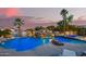 Beautiful backyard pool with a rock waterfall feature, slide, and integrated spa at 5511 N 128Th Dr, Litchfield Park, AZ 85340