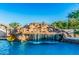 The custom pool includes a rock waterfall with slide and accents the lush backyard at 5511 N 128Th Dr, Litchfield Park, AZ 85340