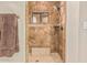 This beautifully tiled shower includes a convenient bench, shower head and frosted window at 5511 N 128Th Dr, Litchfield Park, AZ 85340