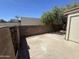 Private backyard featuring a concrete patio, block wall, and mature tree offering outdoor relaxation at 555 N May -- # 29, Mesa, AZ 85201