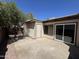 A cozy backyard featuring a concrete patio, storage area, and a mature shade tree at 555 N May -- # 29, Mesa, AZ 85201