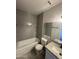 Modern bathroom features gray subway tile, granite counters, and white cabinets at 555 N May -- # 29, Mesa, AZ 85201