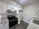 Updated kitchen featuring stainless steel oven, granite countertops, and white cabinets at 555 N May -- # 29, Mesa, AZ 85201