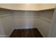 Large walk-in closet features built in shelving, and wood-look floor creating an organized storage space at 555 N May -- # 29, Mesa, AZ 85201
