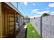 Narrow grass area and storage shed in the backyard, enclosed by a block wall at 5634 N 39Th Ave, Phoenix, AZ 85019