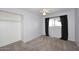 Cozy bedroom with carpet, ceiling fan, closet, and a window with black curtains at 5634 N 39Th Ave, Phoenix, AZ 85019