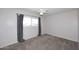 Neutral bedroom with carpet, ceiling fan, and a window with gray curtains at 5634 N 39Th Ave, Phoenix, AZ 85019