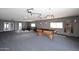 Large bonus room features a pool table, weight bench, and access to an outdoor space at 5634 N 39Th Ave, Phoenix, AZ 85019