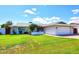 Beautiful single-story home featuring a lush green lawn, white exterior, and attached two-car garage at 5634 N 39Th Ave, Phoenix, AZ 85019
