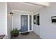 Charming front entry featuring a stylish blue door, side window, and classic exterior lighting at 5634 N 39Th Ave, Phoenix, AZ 85019