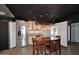 Open kitchen area with stainless steel refrigerator, dining table, and custom lighting at 5634 N 39Th Ave, Phoenix, AZ 85019