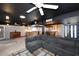 Open-concept living room featuring a kitchen, stylish lighting, and a comfortable sectional sofa at 5634 N 39Th Ave, Phoenix, AZ 85019