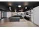 Spacious living room with a modern black ceiling, comfortable seating, and contemporary lighting fixtures at 5634 N 39Th Ave, Phoenix, AZ 85019