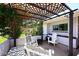 Cozy outdoor patio area with comfortable seating, a trellis, and lush greenery, perfect for relaxing at 5634 N 39Th Ave, Phoenix, AZ 85019