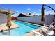 Inviting backyard pool with lounge chairs and sun umbrellas offers relaxation at 5634 N 39Th Ave, Phoenix, AZ 85019