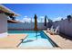 Inviting backyard pool area features clear water, tanning ledge, umbrellas and chairs for relaxation at 5634 N 39Th Ave, Phoenix, AZ 85019