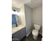 Compact bathroom showcasing a sleek vanity with granite countertops and updated fixtures at 5723 N 44Th Ln, Glendale, AZ 85301