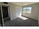 Cozy bedroom featuring a view of the community pool, ample natural light, and comfortable carpeting at 5723 N 44Th Ln, Glendale, AZ 85301