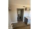 Interior view of the hallway featuring granite countertops in the kitchen and natural lighting at 5723 N 44Th Ln, Glendale, AZ 85301