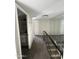 Well-lit hallway with mirrored wall and access to a bathroom, enhanced by neutral-toned walls and plush carpeting at 5723 N 44Th Ln, Glendale, AZ 85301