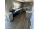 Modern kitchen showcasing stainless steel appliances, granite countertops, and wood flooring at 5723 N 44Th Ln, Glendale, AZ 85301