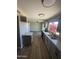 Bright kitchen features stainless steel appliances, granite countertops, and views to the spacious living area at 5723 N 44Th Ln, Glendale, AZ 85301