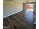 Spacious living room featuring wood flooring, neutral paint, and bright natural light at 5723 N 44Th Ln, Glendale, AZ 85301