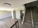 Open stairway leading to the upper level with iron railing and an adjacent living space at 5723 N 44Th Ln, Glendale, AZ 85301