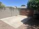 Backyard with concrete patio, gravel, block fence, and wooden gate at 621 W Desert Ave, Gilbert, AZ 85233
