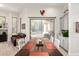 Bright dining area with farmhouse style table and decor opens to the outdoor living space through sliding glass door at 621 W Desert Ave, Gilbert, AZ 85233