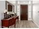 Stylish entryway with a wooden console table, elegant decor, and wood-look floors at 621 W Desert Ave, Gilbert, AZ 85233