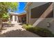 Exterior view of home and covered patio with brick pavers, outdoor furniture, a built-in barbecue, and a well-manicured landscape at 621 W Desert Ave, Gilbert, AZ 85233