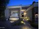 Inviting home exterior featuring a stone facade, tile roofing, and a lit walkway to an inviting front entrance at 621 W Desert Ave, Gilbert, AZ 85233