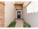 Inviting entryway with a decorative security door, brick walkway, and manicured greenery at 621 W Desert Ave, Gilbert, AZ 85233