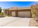Attractive home showcasing a spacious driveway leading to a two-car garage and desert landscaping at 621 W Desert Ave, Gilbert, AZ 85233