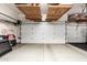 Clean garage featuring an epoxy floor, two garage doors, overhead racks for storage, and lots of space at 621 W Desert Ave, Gilbert, AZ 85233