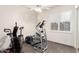 A room full of exercise equipment in the house, including an elliptical, bike, and weight bench at 621 W Desert Ave, Gilbert, AZ 85233