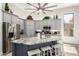 Bright kitchen with large center island, gray cabinets, stainless steel appliances, and decor above upper cabinets at 621 W Desert Ave, Gilbert, AZ 85233